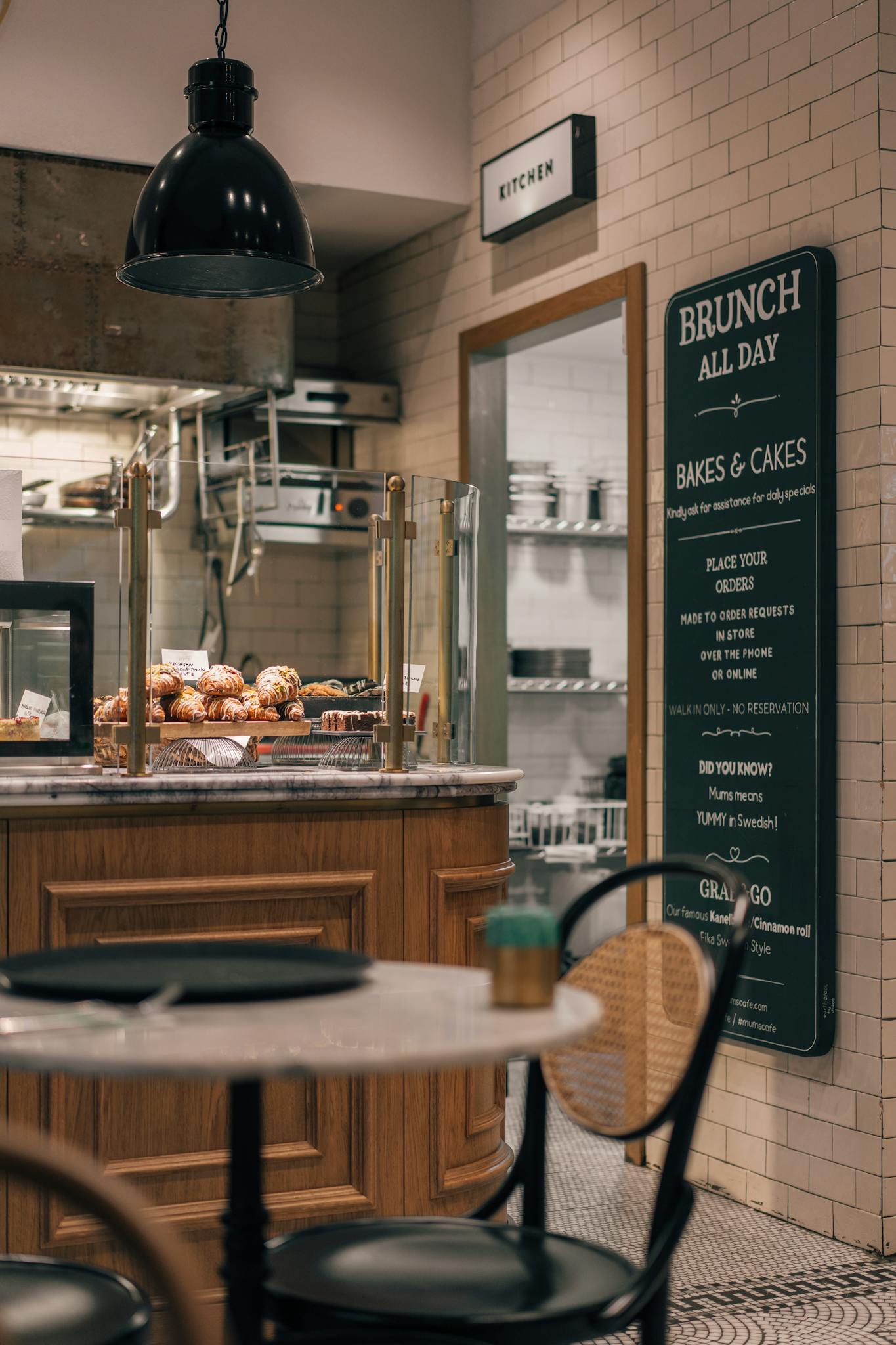Stylish Istanbul café interior featuring a brunch menu and baked goods on the counter.